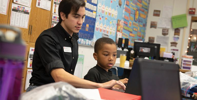 Senior Colton Brucks tutors a fourth grader at Sheridan Elementary in Bloomington. Brucks is one of more than 100 tutors in America Reads, a federal program administered by Illinois State’s Financial Aid Office.