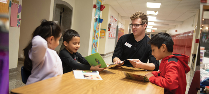 Jake Welker, a sophomore at Illinois State, tutors students in a second grade bilingual class at Bent Elementary in Bloomington. 